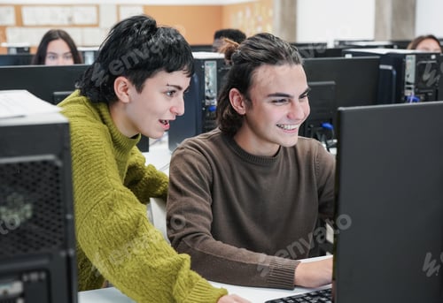 Preview: Young diverse students doing research at school inside computer classroom
