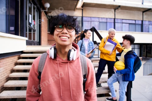 Preview: Close up shot of cheerful happy Asian teenage guy looking at camera smiling.