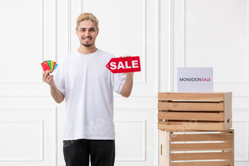 Preview: monsoon sale young salesman offering discount at store with many debit cards ready to spend