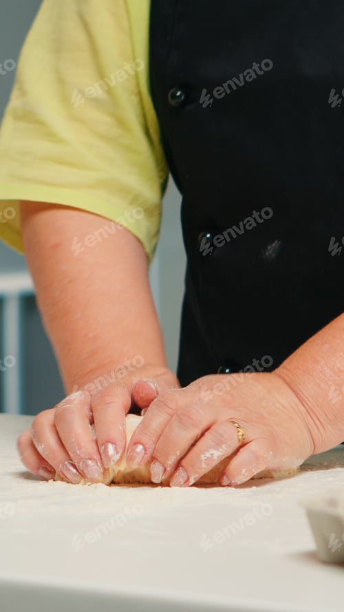 Preview: Woman hands kneading dough on table