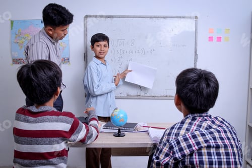 Preview: Schoolboy Asian student presenting project to friends at the classroom