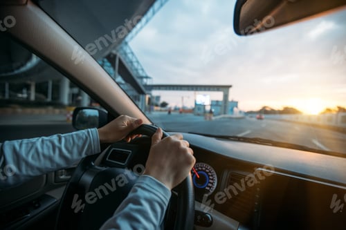 Preview: DrivingPeople driving car on sunrise city road