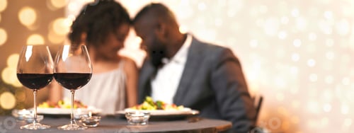 Preview: Two glasses of red wine on festive dinner table