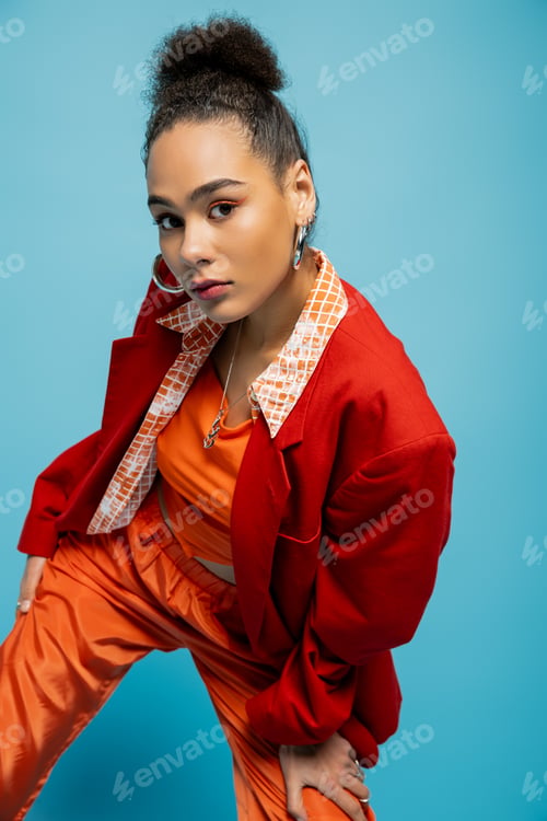 Preview: close up attractive african american in stylish urban suit and accessories posing looking at camera