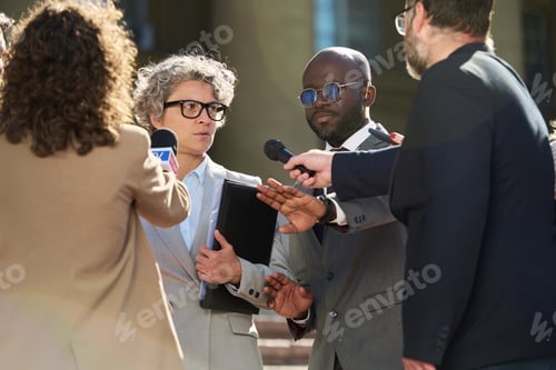 Preview: Middle Aged Caucasian Woman and Black Man Giving Interview to Journalists Outside