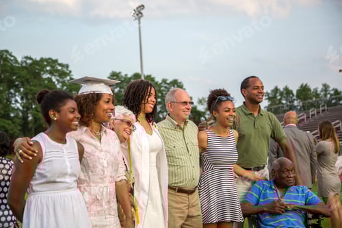 Preview: Teenage girl with large family at graduation ceremony