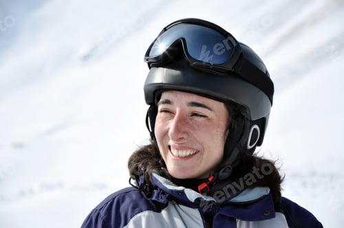 Preview: Portrait of a smiling skier woman with helmet in the Alps