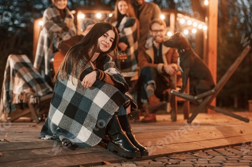 Preview: Portrait is sitting in front of her friends. Group of people is spending time together