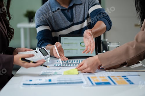 Preview: Businessmen write project ideas and use laptops to edit papers for brainstorming sessions
