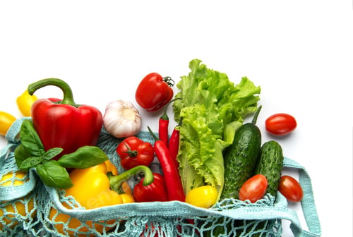 Preview: Fresh organic vegetables in reusable shopping bag on white