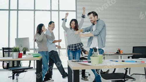 Preview: Asian creative business women and men enjoy and having fun dancing while working in her office.