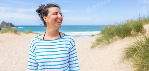 Preview: Happy young woman at seaside in Cornwall