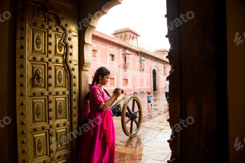 Preview: Woman tourist taking photos travel spots in Jaipur, India.