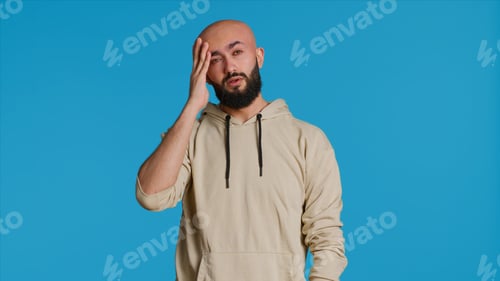 Preview: Adult Man Wearing Hoodie With Hand on Head