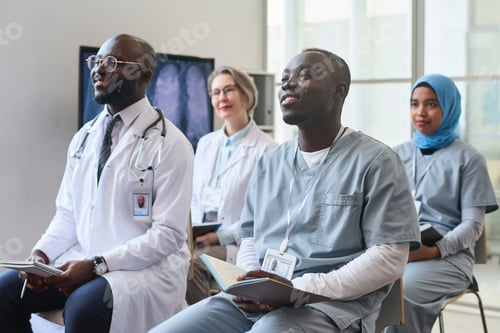 Preview: Doctors making notes at conference