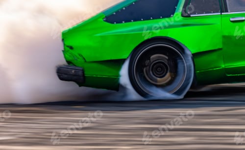 Preview: Blurred car drifting diffusion race drift car with lots of smoke from burning tires on speed track.