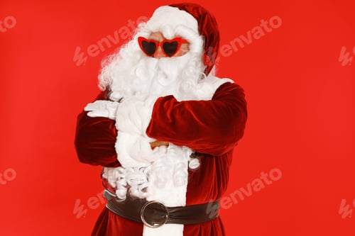 Preview: Authentic Santa Claus wearing sunglasses on red background