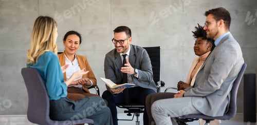 Preview: Team of colleagues sitting in office and listening to coach sharing his advice and expertise