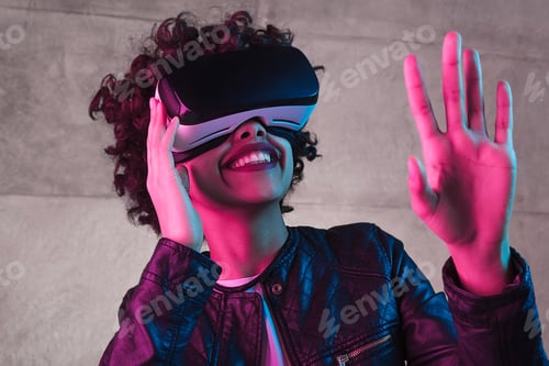Preview: Smiling black teenager interacting with virtual reality