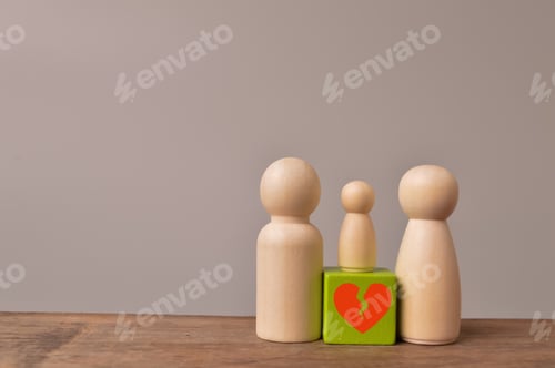 Preview: Wooden doll figures of family with break love heart. Concept of divorce