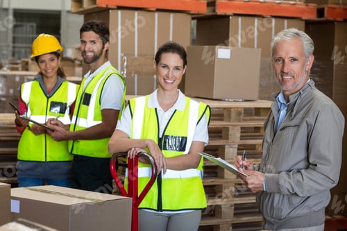 Preview: Portrait of warehouse manager and workers preparing a shipment