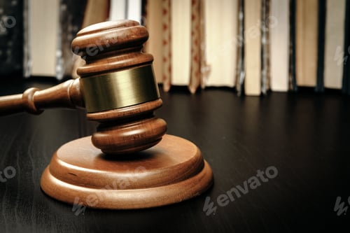 Preview: Judge's gavel on wooden table in dark