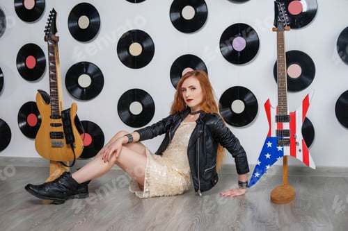 Preview: Sexy Woman In A Sequin Dress, Leather Jacket And Red Lips. Disco Style. Girl Hipster Playing The
