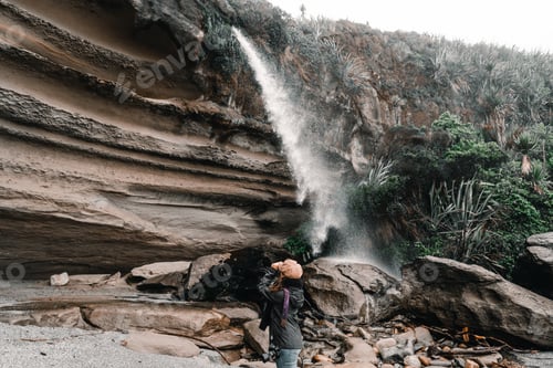 Preview: caucasian girl standing with a reflex camera slung on her left shoulder admiring the grandeur of the