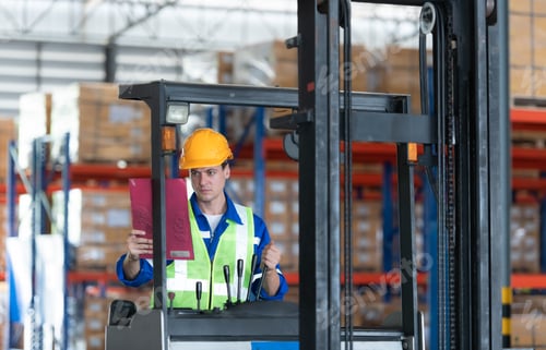 Preview: Worker in auto parts warehouse use a forklift to work to bring the box of auto parts
