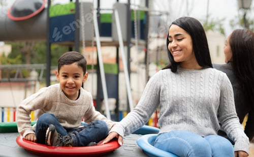 Preview: Portrait of mother and son having fun in a playground together
