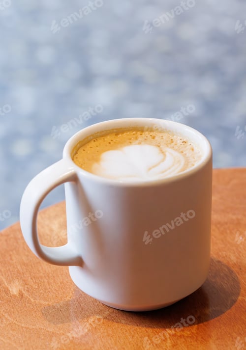 Preview: Warm cappuccino in a cup with latte art on top
