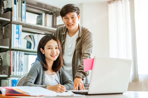 Preview: Portrait of two students are reading and discussing about exam preparation, presentation, study for