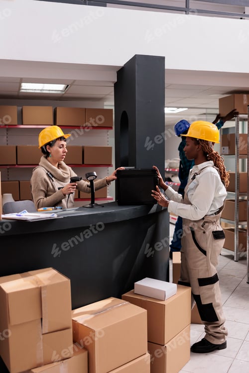 Preview: Warehouse manager scanning case at counter desk, doing inventory