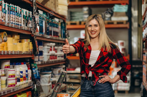 Preview: happy female customer shopping in hardware store.