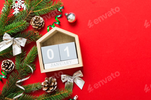 Preview: Christmas calendar 1 january. Christmas gift, fir branches, pine cones. Flat lay, top view