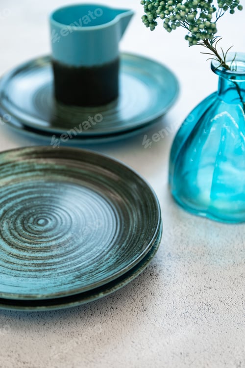 Preview: Ceramic set of blue empty kitchen plates on a white marble background. Eco and minimal tableware.