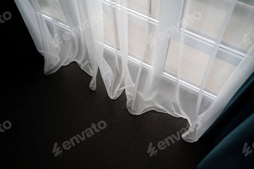 Preview: Sheer White Tulle Curtains Draping Gracefully Over a Sunlit Window in a Cozy Home Setting