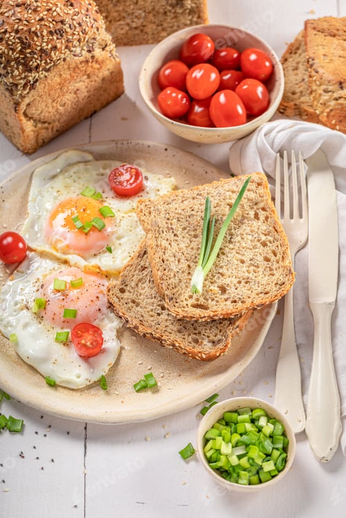 Preview: American breakfast with fried eggs, bread and chive.