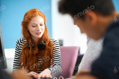 Preview: Young male and female college students at computer desk teamworking