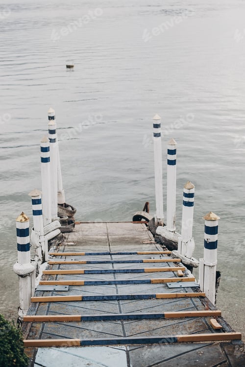 Preview: Beautiful old wooden dock with aged columns in white and blue colors
