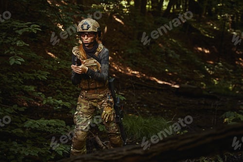 Preview: Female person wearing camouflage uniform and helmet