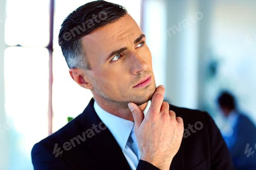 Preview: Pensive Businessman Standing In Front Of Colleagues