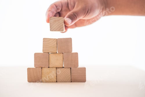 Preview: The hand of the businessman caught the wooden blocks placed on a white background