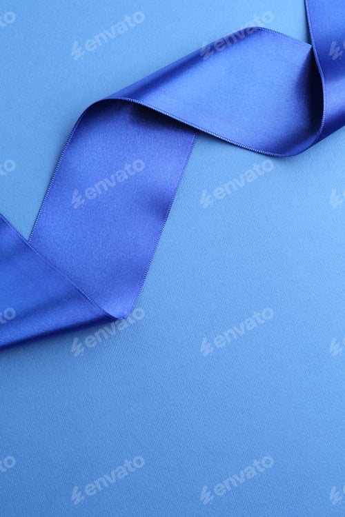 Preview: Beautiful ribbon on blue background, top view. Space for text