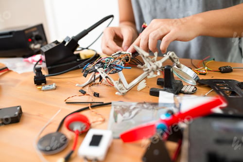 Preview: Man installing the component on drone body
