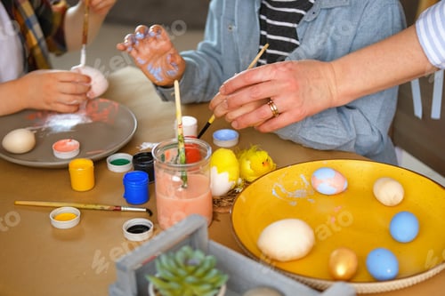 Preview: Little boy painting eggs for Easter