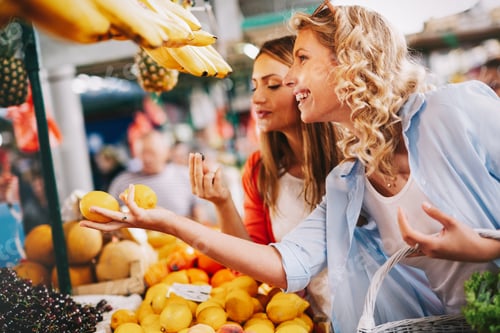 Preview: Young women friends baying vegetables and fruits on the market