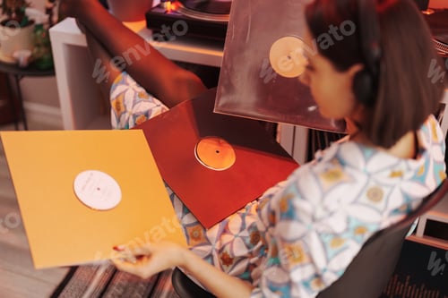 Preview: Young woman enjoying vinyl records in cozy room