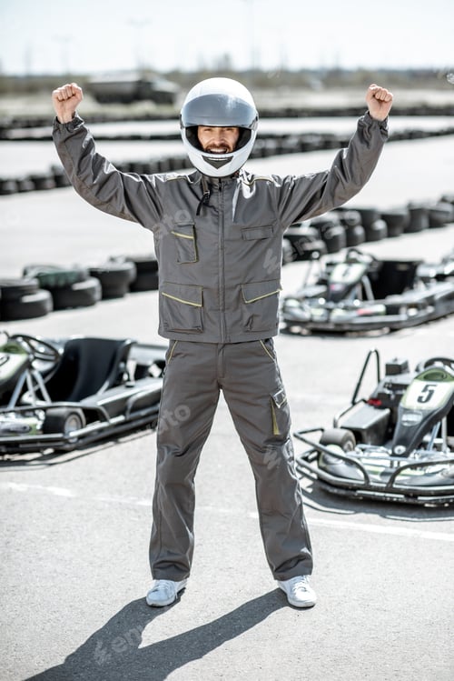 Preview: Excited Man in Racing Suit Celebrating Go-Kart Win