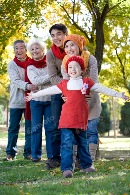 Preview: Chinese three generation family playing in a park in autumn